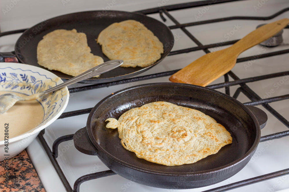 Pita bread in pan on plate. Dough on plate. Homemade bread. Pita bread in pan on plate. Dough on plate. Homemade bread.
