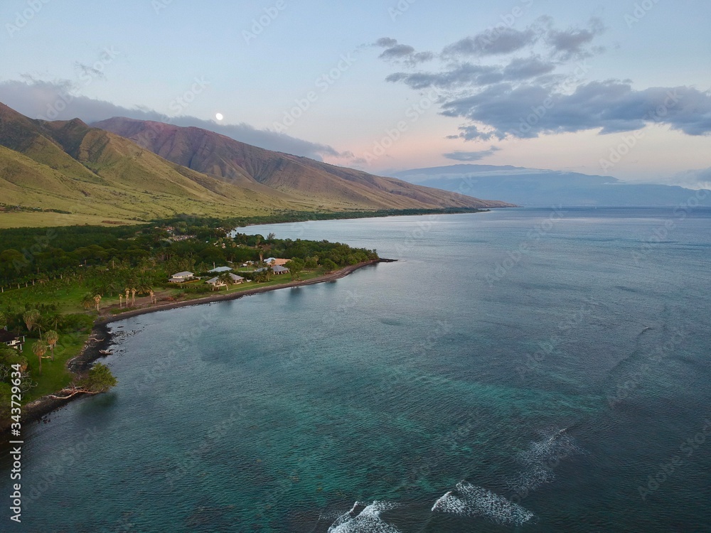 Aerial capture of Olowalu, looking towards the Pali and Haleakala with the Moon rising in the background