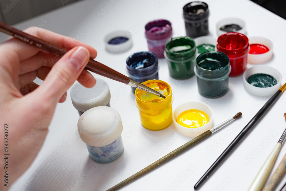 Paint palette with various acrylic paints and a brush Stock Photo