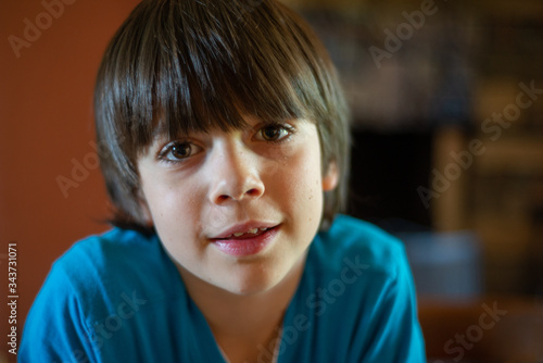 portrait of child ten years old he look on the camera and smile - headshoot of kid at home
