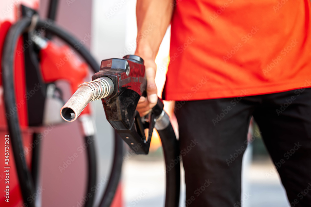 Close-up hands refueling in car,The petrol station staff is refilling the car for customers,Refill fuel in car at gas station,Focus hands refilling. Close-up hands refueling in car,The petrol station staff is refilling the car for customers,Refill fuel in car at gas station,Focus hands refilling.