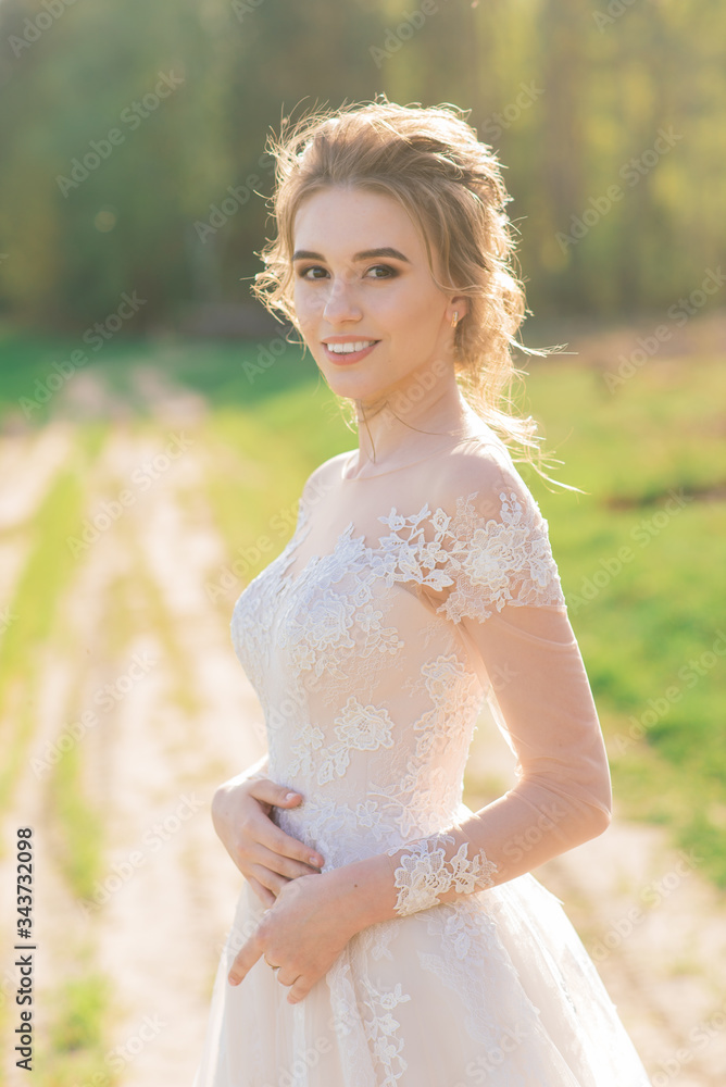 Young beautiful woman in blooming garden. Bride. Young beautiful woman in blooming garden. Bride.