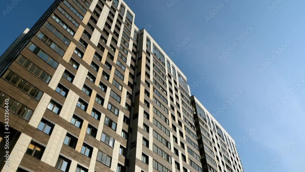 Exterior of a modern high-rise building against blue sky. HD Exterior of a modern high-rise building against blue sky. HD
