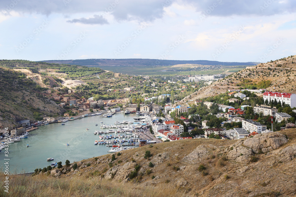 View from the mountain to the closed Bay, sailing Marina, Balaclava. Landscape, view of the sea city, fishing pier. 