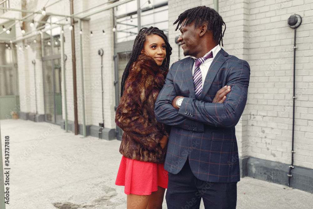 Naklejka premium Black couple. Woman in a red dress. Man in a suit.