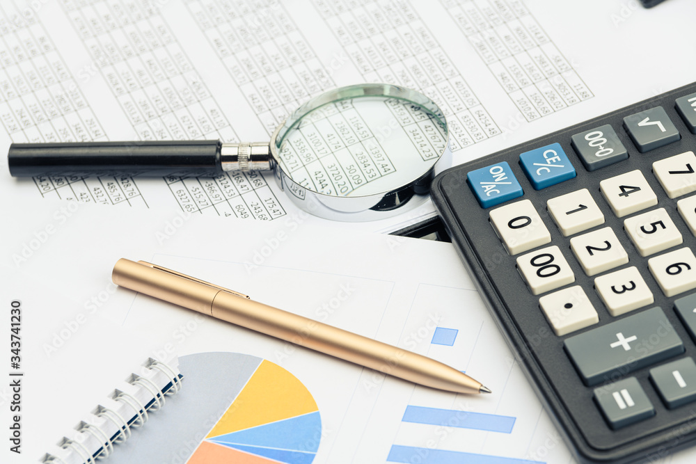 Business financial documents, office calculator and pen on the table. Numbers and graphs Business financial documents, office calculator and pen on the table. Numbers and graphs