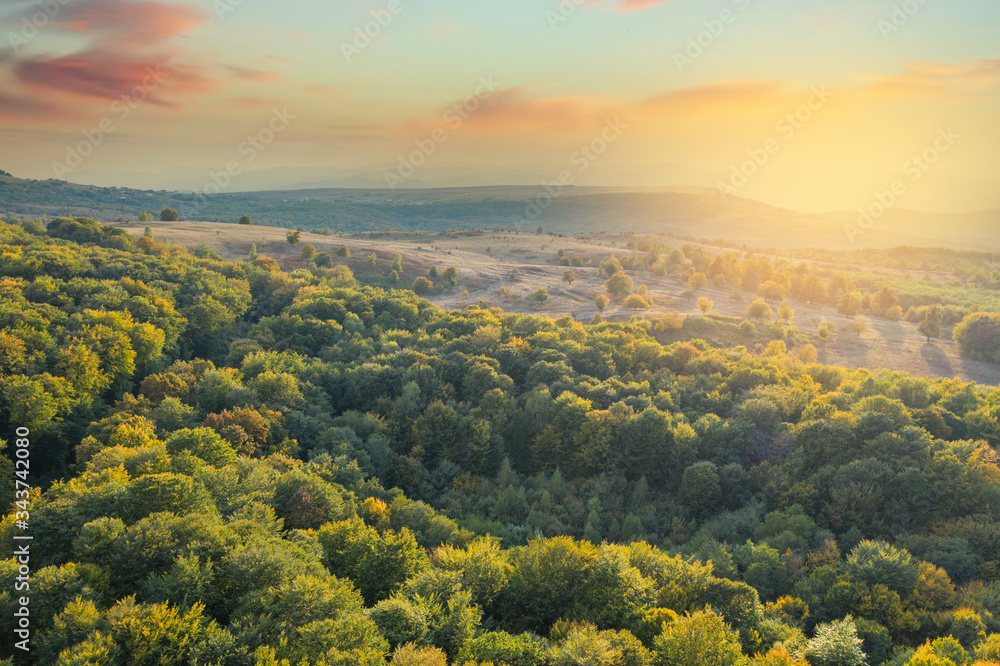 Beautiful sunset over autumnal landscape seen from a drone. Wanderlust concept. 