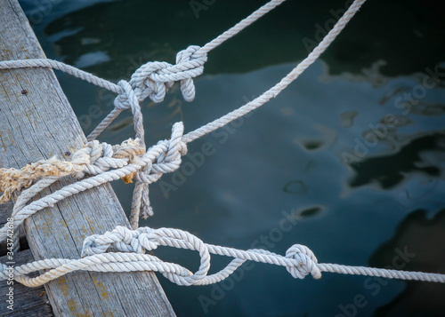 knots on sea ropes are tied to a wooden Board or pier. The concept of safety on the water.