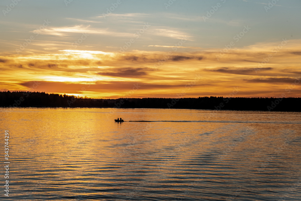 beautiful sunset on the river on which the boat floats and the horizon and the forest are visible behind, 
lake, sunset, water, river,
the boat is sailing, 2 people are sailing in a boat