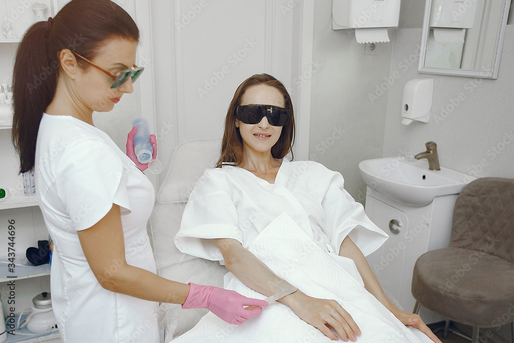 Hair removal. Gel for laser. Woman in a pink gloves. Hair removal. Gel for laser. Woman in a pink gloves.