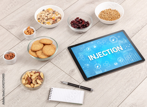 Healthy Tablet Pc compostion with INJECTION inscription, immune system boost concept