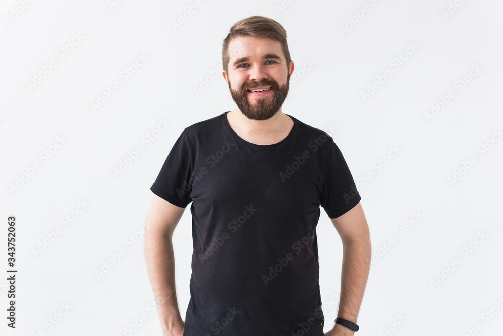 Cheerful guy smiled happily, has excited expression over white studio background. Holidays, youth, emotions concept. Cheerful guy smiled happily, has excited expression over white studio background. Holidays, youth, emotions concept.
