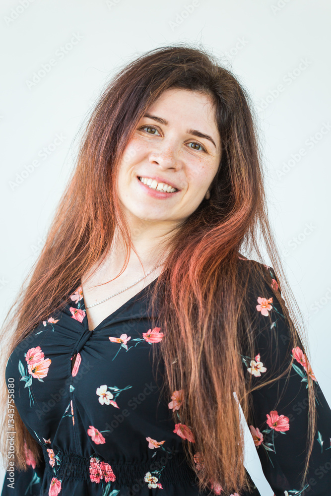 Playful and happy funny redhead woman having fun laughing on a white background. Playful and happy funny redhead woman having fun laughing on a white background.