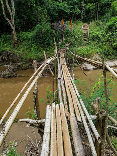 Wood bamboo bridge over river water pai cave tour tourism chiang mai thailand hiking adventure photo