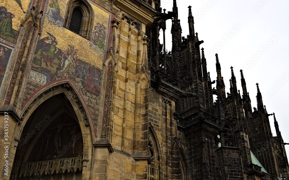 Prague, Czech Republic - 28 December 2019: Exterior details of St. Vitus Cathedral, a gothic religious building with towers, spires and mosaic decorations