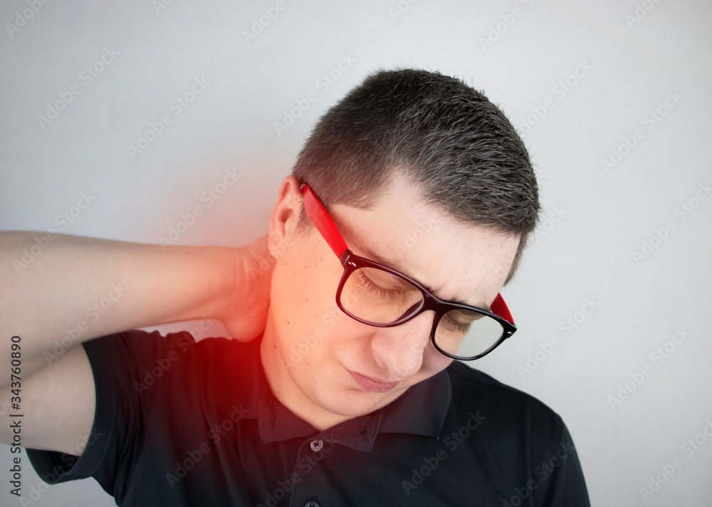 A man suffers from pain in the neck, massages the cervical spine with his hand. Osteochondrosis, hernia, or nerve injury due to sedentary work or physical stress A man suffers from pain in the neck, massages the cervical spine with his hand. Osteochondrosis, hernia, or nerve injury due to sedentary work or physical stress