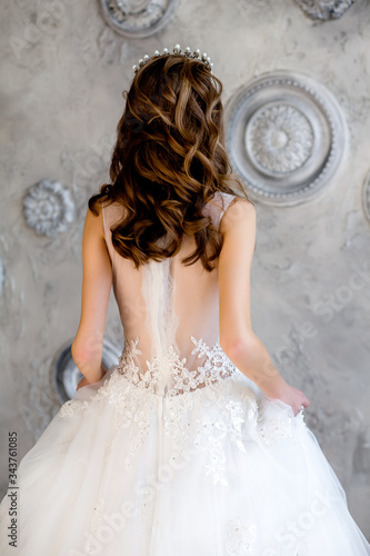 Portrait of an attractive young woman with a beautiful wedding hairstyle and a stylish hair accessory.