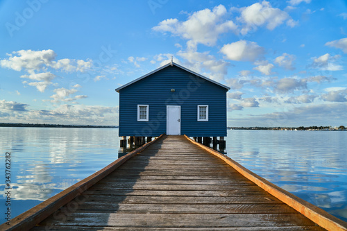 Fototapeta Rustic blue house on the water