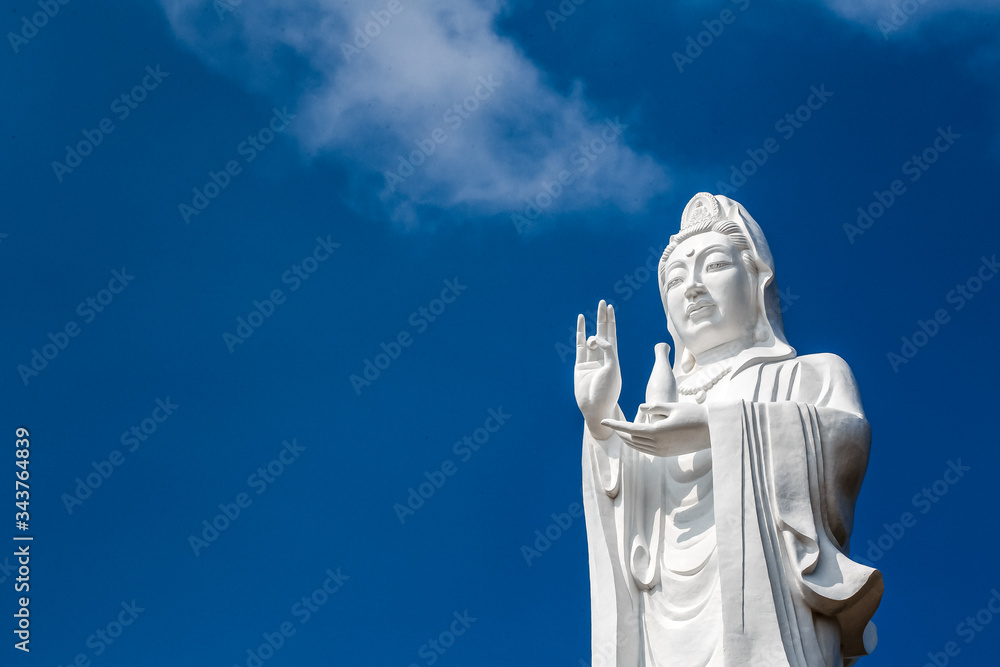 Big white statue of buddha at the blue sky