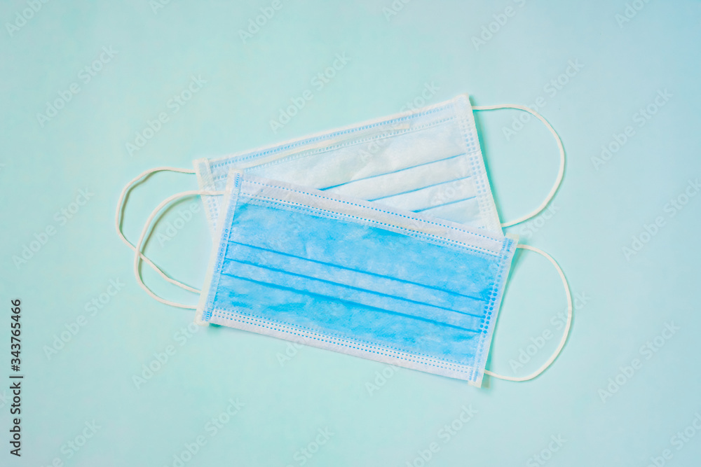 surgical masks with blue paper background, flat lay surgical masks with blue paper background, flat lay