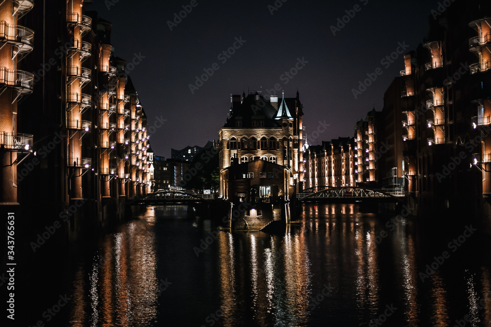 Night view of the old town. Reflection of houses and lights in the river
