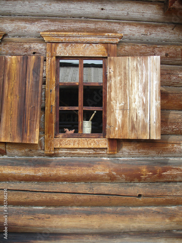 old window with wooden shutters in a wooden house
