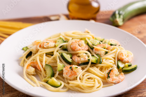 Spaghetti with shrimps and zucchini. Typical dish on italian cuisine. Summer lunch.