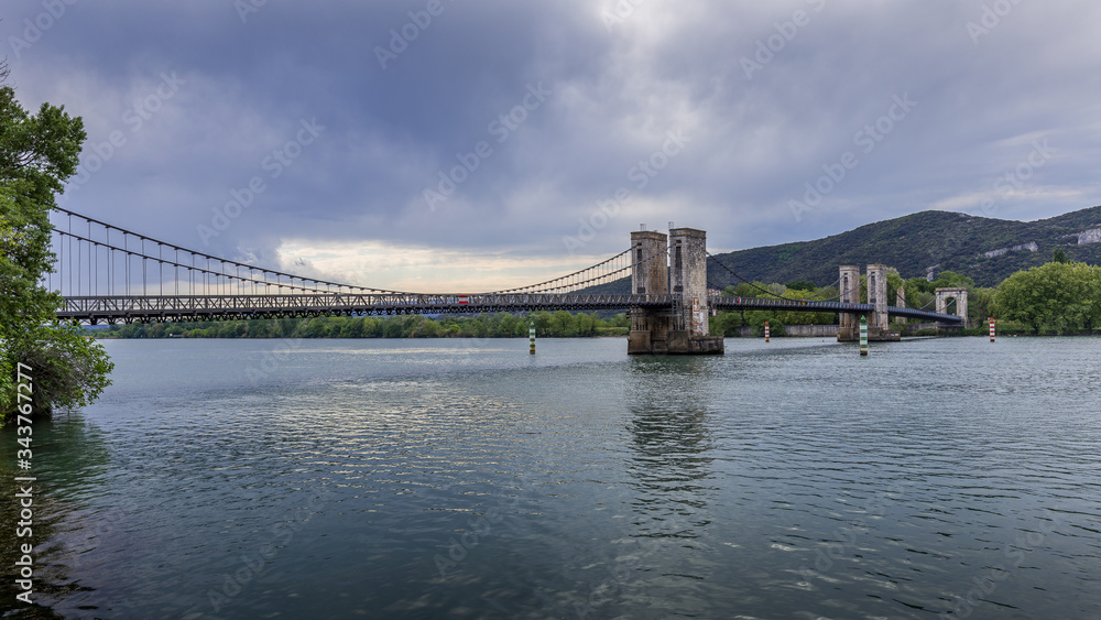 View of the Pont du Robinet bridge with a cloudy sky highlighting its  metallic structure, Donzère, France Stock Photo | Adobe Stock