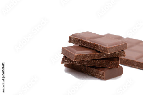 Pieces of chocolate on a white background, isolate. Broken chocolate bar