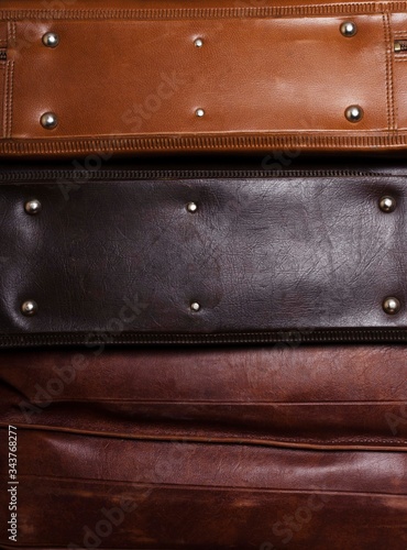 Vertical image of bottoms of leather suitcases.Texture of luggage