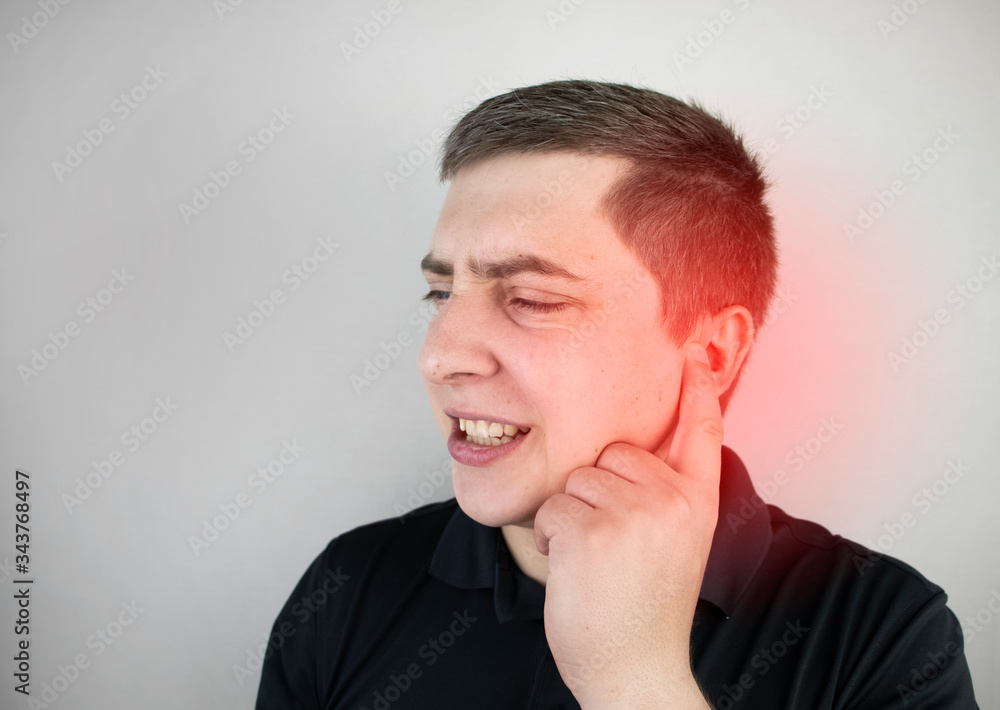 A man suffers from pain in the ear. The auditory meatus hurts due to otitis media, cerumen plug, ear boil, or trigeminal neuralgia A man suffers from pain in the ear. The auditory meatus hurts due to otitis media, cerumen plug, ear boil, or trigeminal neuralgia