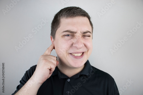 A man suffers from pain in the ear. The auditory meatus hurts due to otitis media, cerumen plug, ear boil, or trigeminal neuralgia