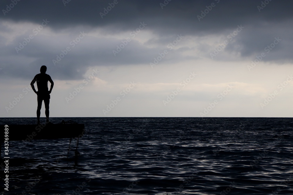 silhouette of a man standing on the beach silhouette of a man standing on the beach