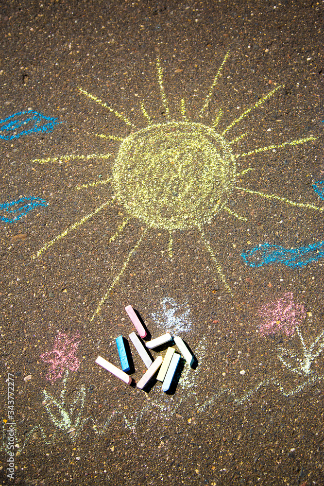 sun is drawn in chalk on the pavement