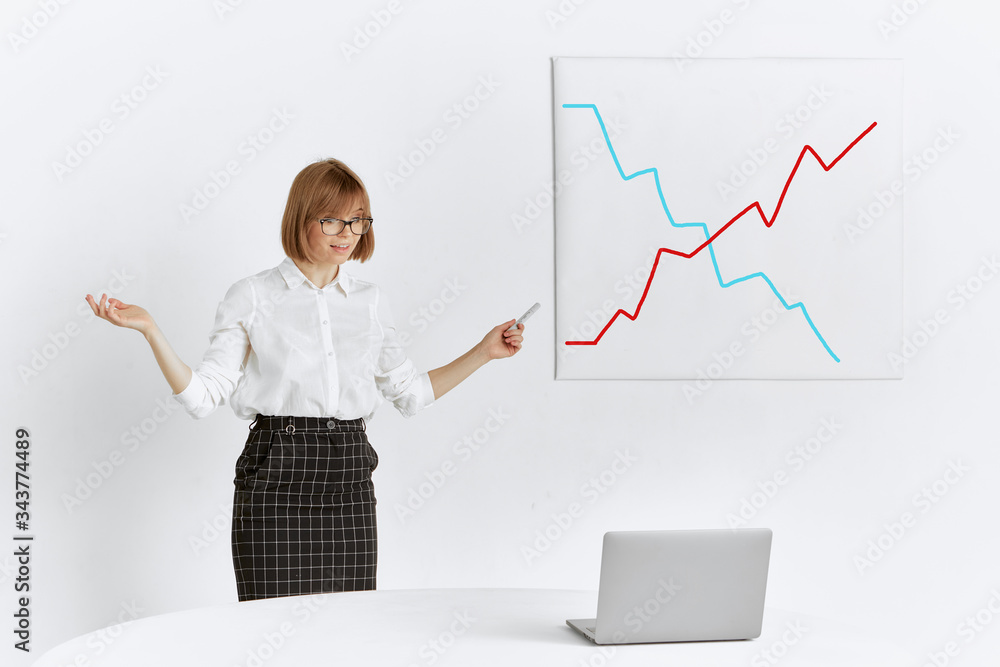 A pretty girl gives a presentation to colleagues remotely at an online conference on a laptop while staying at home. A pretty girl gives a presentation to colleagues remotely at an online conference on a laptop while staying at home.
