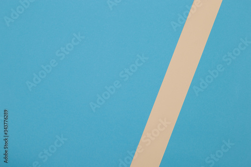 Blue and yellow background, colored paper geometrically divides into zones, frame, copy, space.