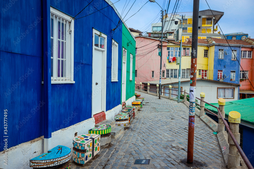 Obraz premium Panoramiczny widok na górskie wzgórza z kolorowymi i jasnymi budynkami z malowaniem, Valparaiso, Chile