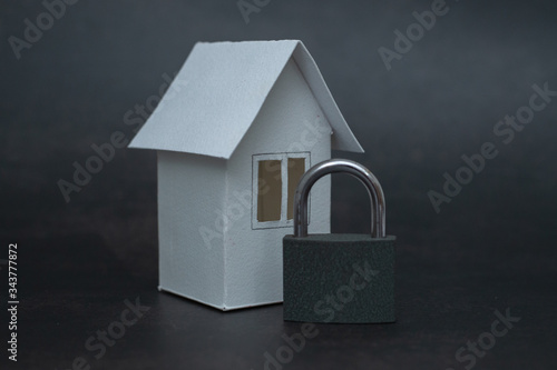 Stay home concept. Lock and house on background. © Sandu