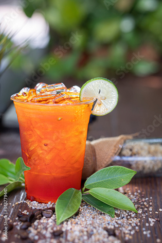 a glass of cool lemon tea on wooden floor