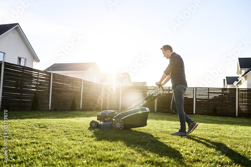 Obraz na plátně Spring mowing the lawn