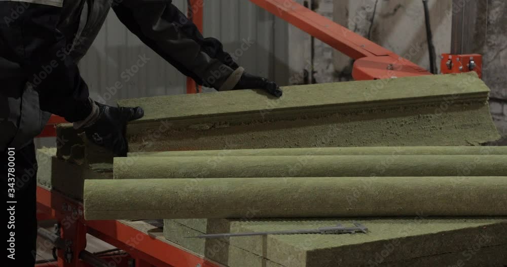 Crop stock video of a professional worker in uniform working with heat-insulating for pipes at a factory. Crop stock video of a professional worker in uniform working with heat-insulating for pipes at a factory.