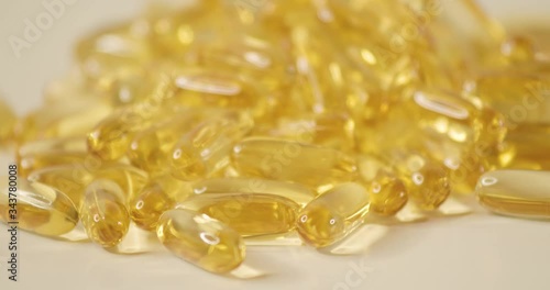 Close up shot of vitamin supplement of cod liver oil capsules with changing light. photo