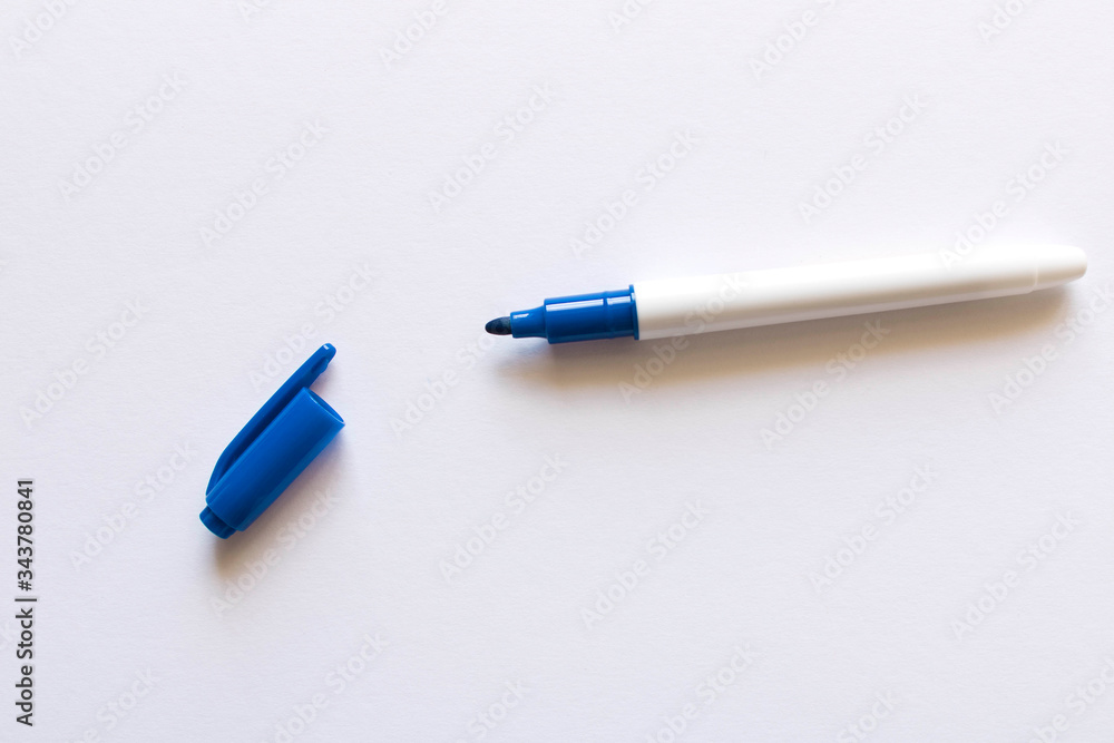 Blue marker on a light background. Selective focus. Blue marker on a light background. Selective focus.