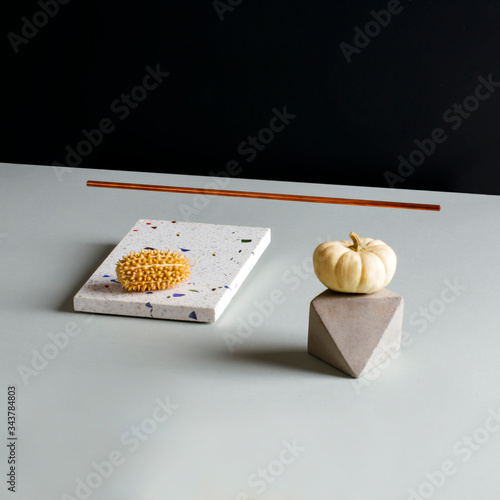 Pumpkin, stone and tile on table