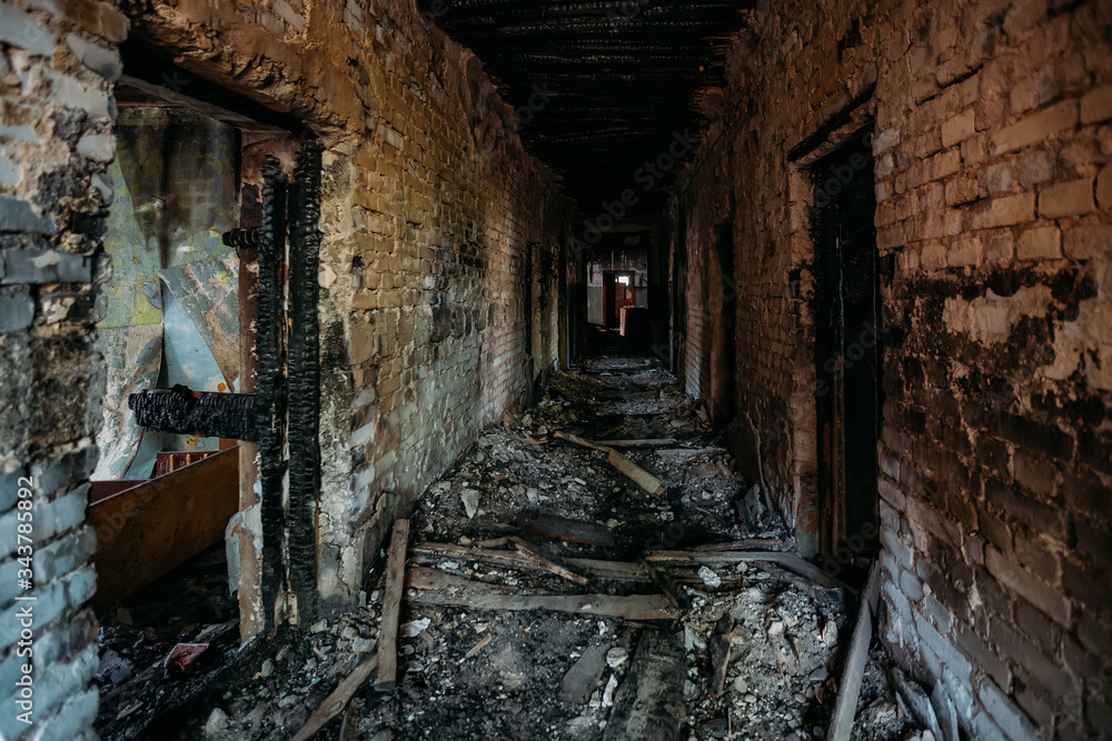 Burnt old house interior. Ruined coridor walls in black soot ...