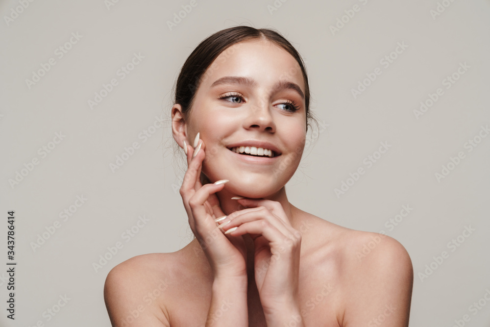 Image of happy nice shirtless woman smiling and looking aside Image of happy nice shirtless woman smiling and looking aside