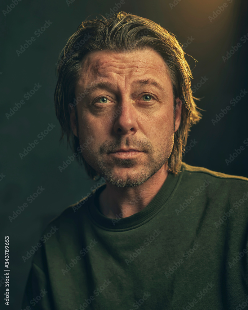 Fototapeta premium Middle aged man with stubble beard in green sweater.