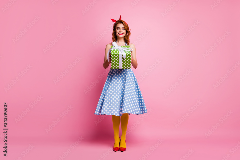 Full length photo of cheerful sweet pretty girl hold big green polka-dot bright gift box she get receive on 8-march anniversary wear blue stockings shoes isolated over pink color background Full length photo of cheerful sweet pretty girl hold big green polka-dot bright gift box she get receive on 8-march anniversary wear blue stockings shoes isolated over pink color background