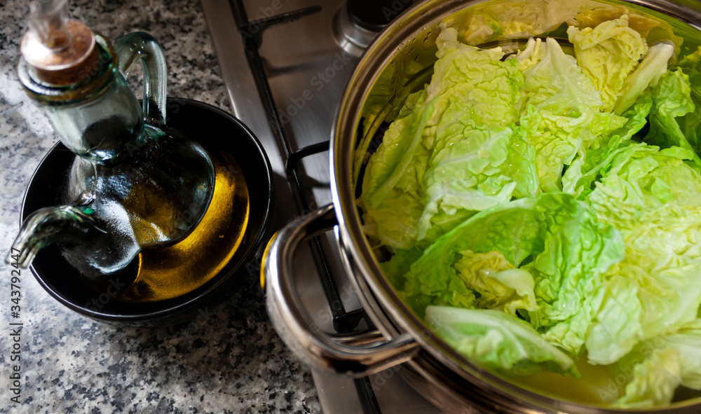 Pot with cabbage and an oil can with olive oil Pot with cabbage and an oil can with olive oil