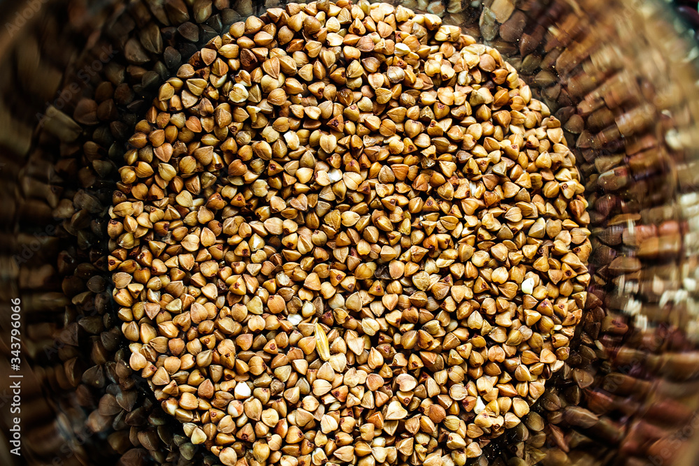Obraz premium Buckwheat grits background. Buckwheat grains. Buckwheat circle. Buckwheat porridge scatter.